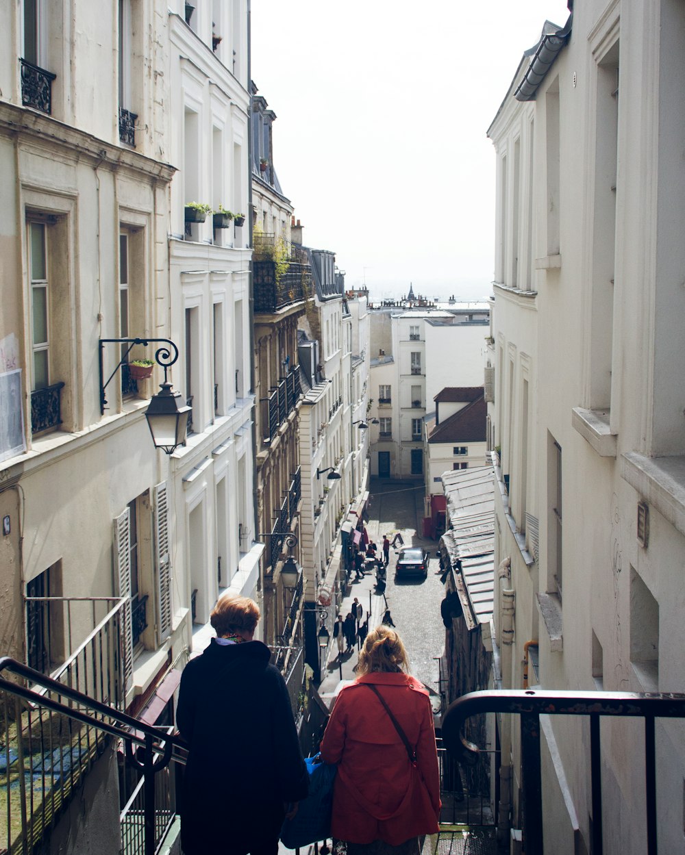 a couple of people that are walking down some stairs