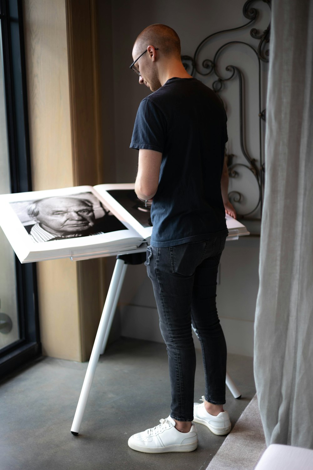 a man standing in front of a table with a picture on it