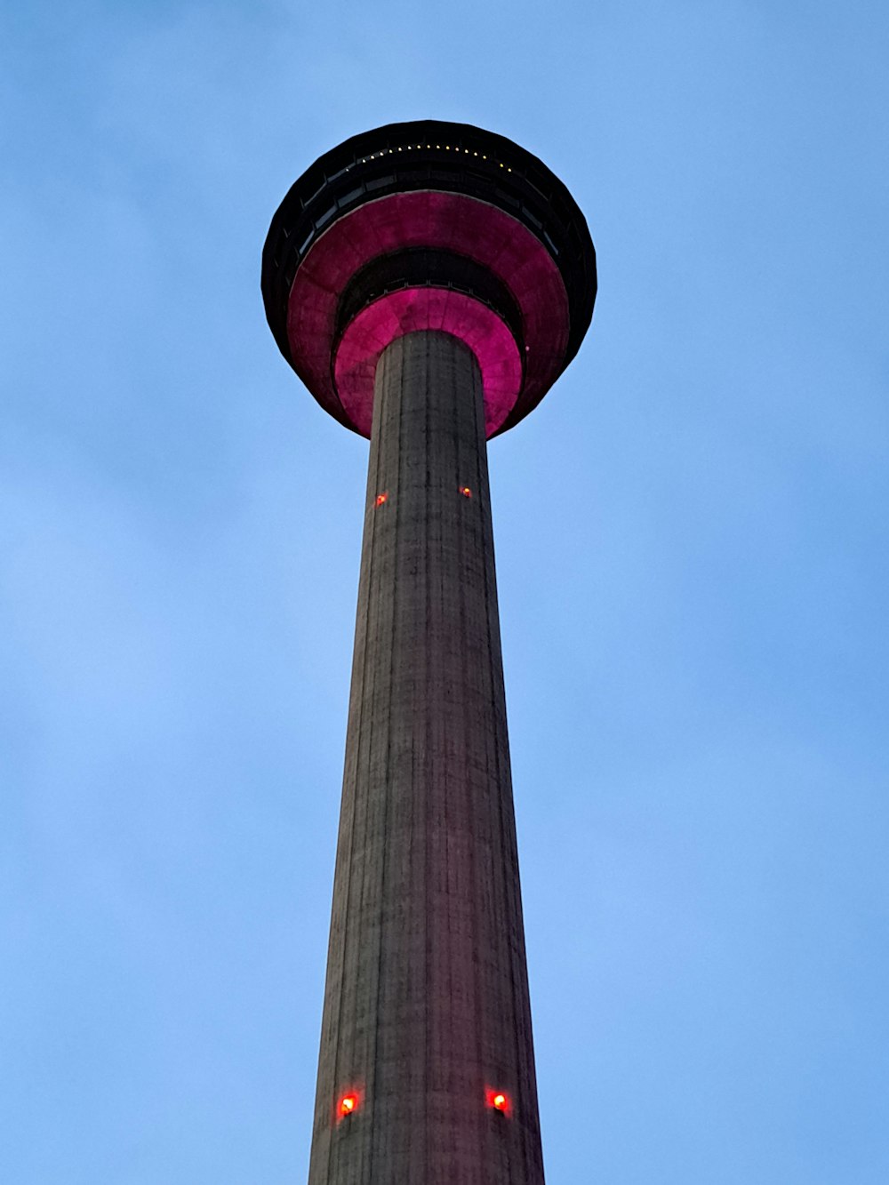 a tall tower with a red light on top
