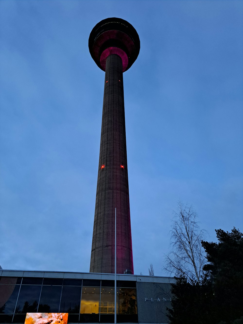 a tall tower with a red light on top of it