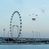 Nighttime view of the Singapore Flyer illuminated against the dark sky
