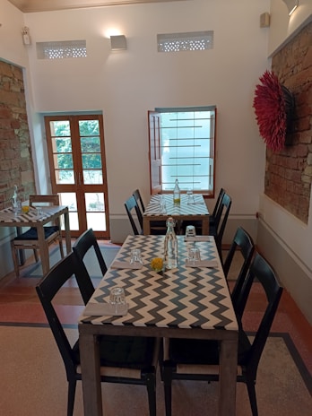 A sleek dining set combining metal frames with warm wooden surfaces in a sunlit room.