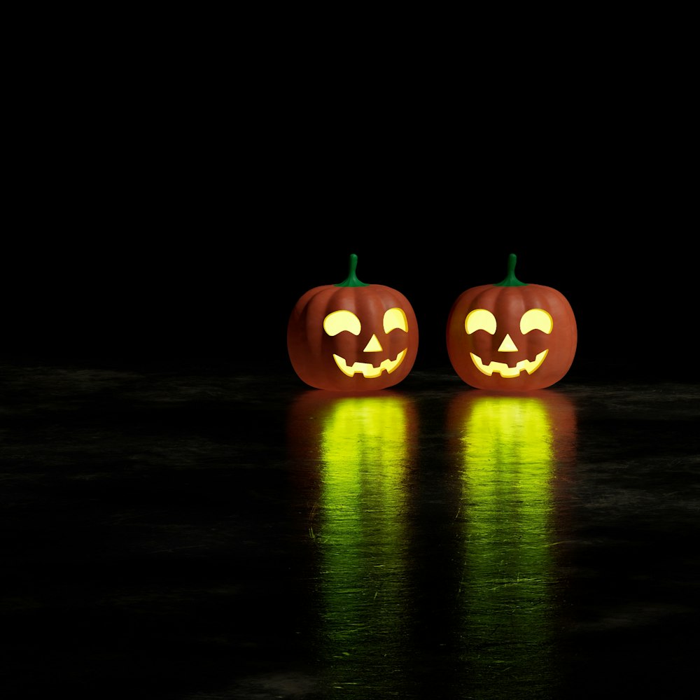 two jack o lantern pumpkins sitting on a table