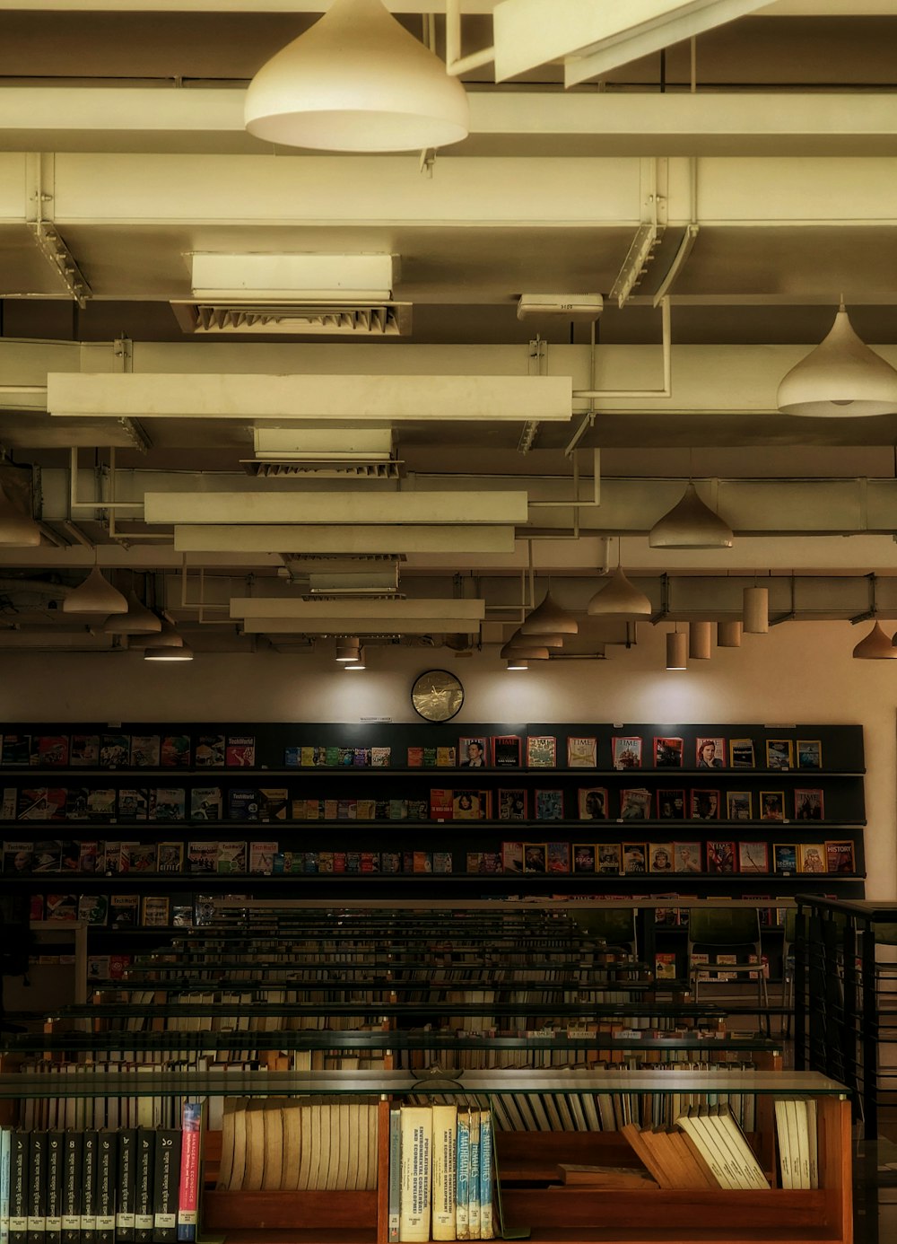 a library filled with lots of books under lights
