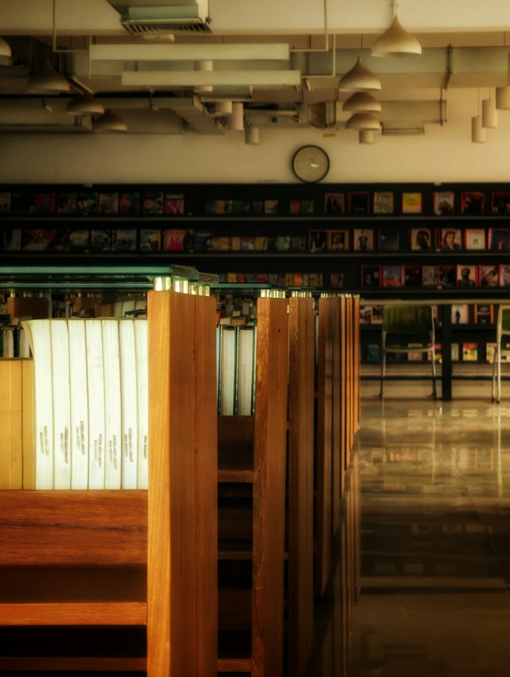 a row of wooden benches in a library