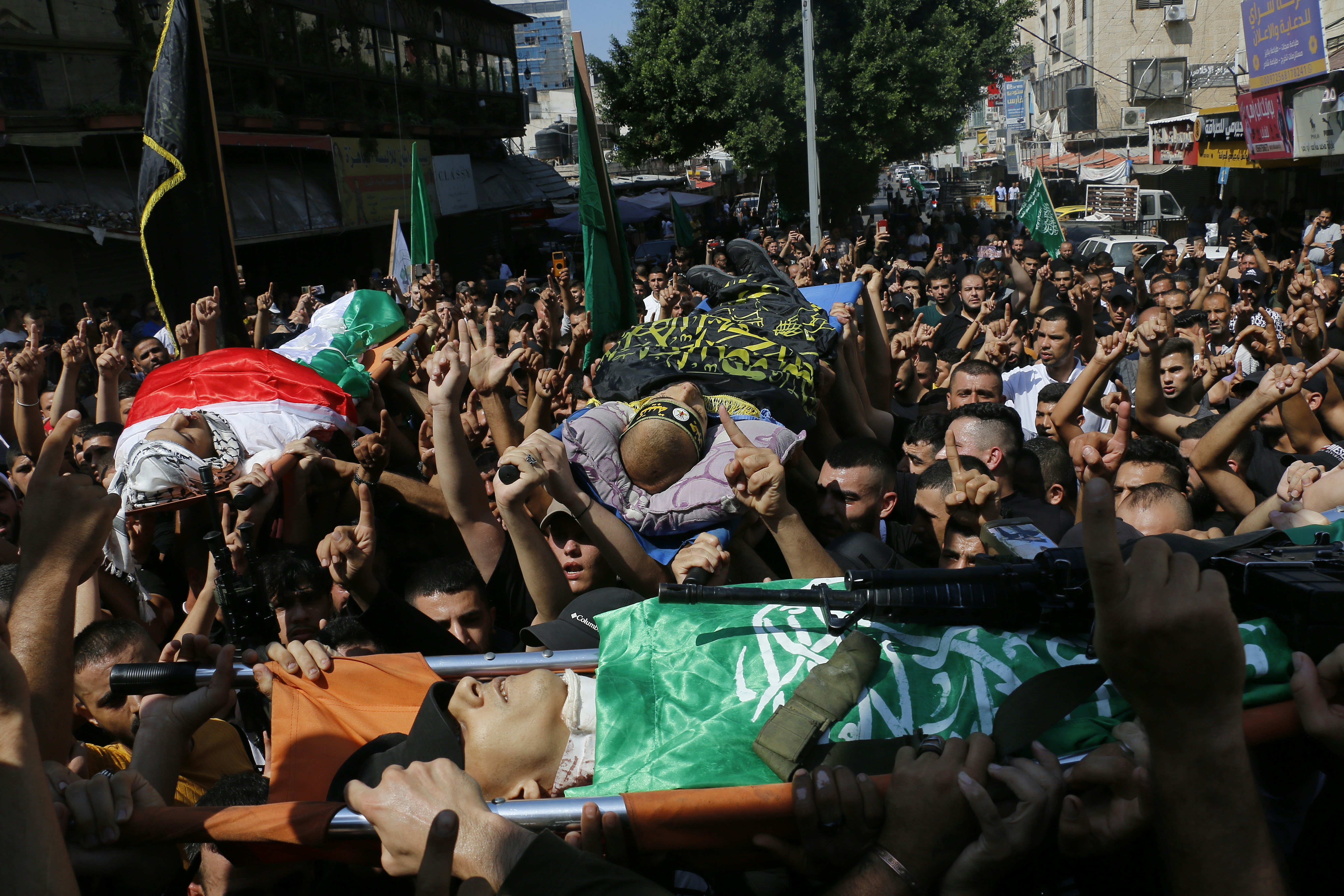 a large crowd of people holding up flags
