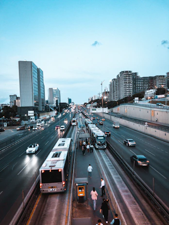 A smooth asphalt road bustling with trucks and buses, showing improved transportation and connectivity.