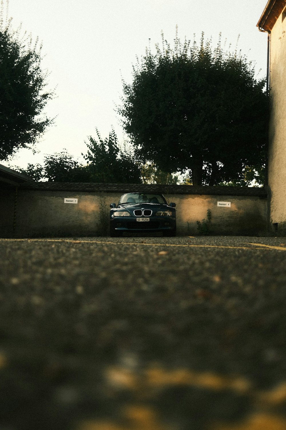 a car parked in a driveway next to a building