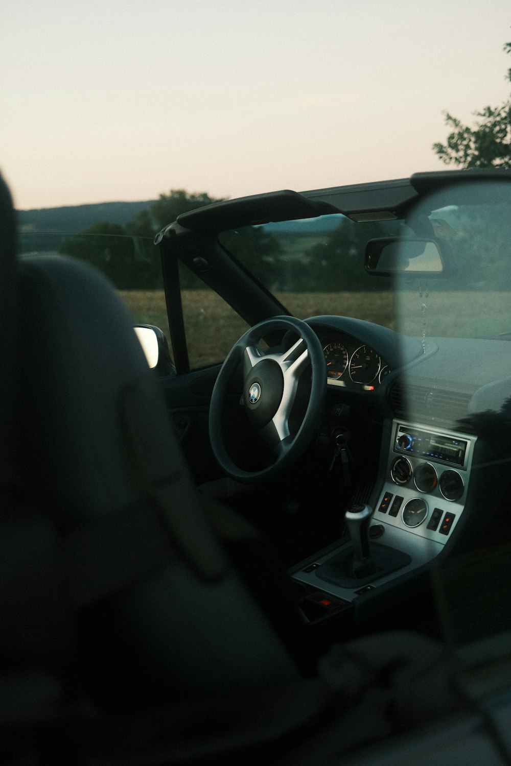 the interior of a car with a steering wheel and dashboard