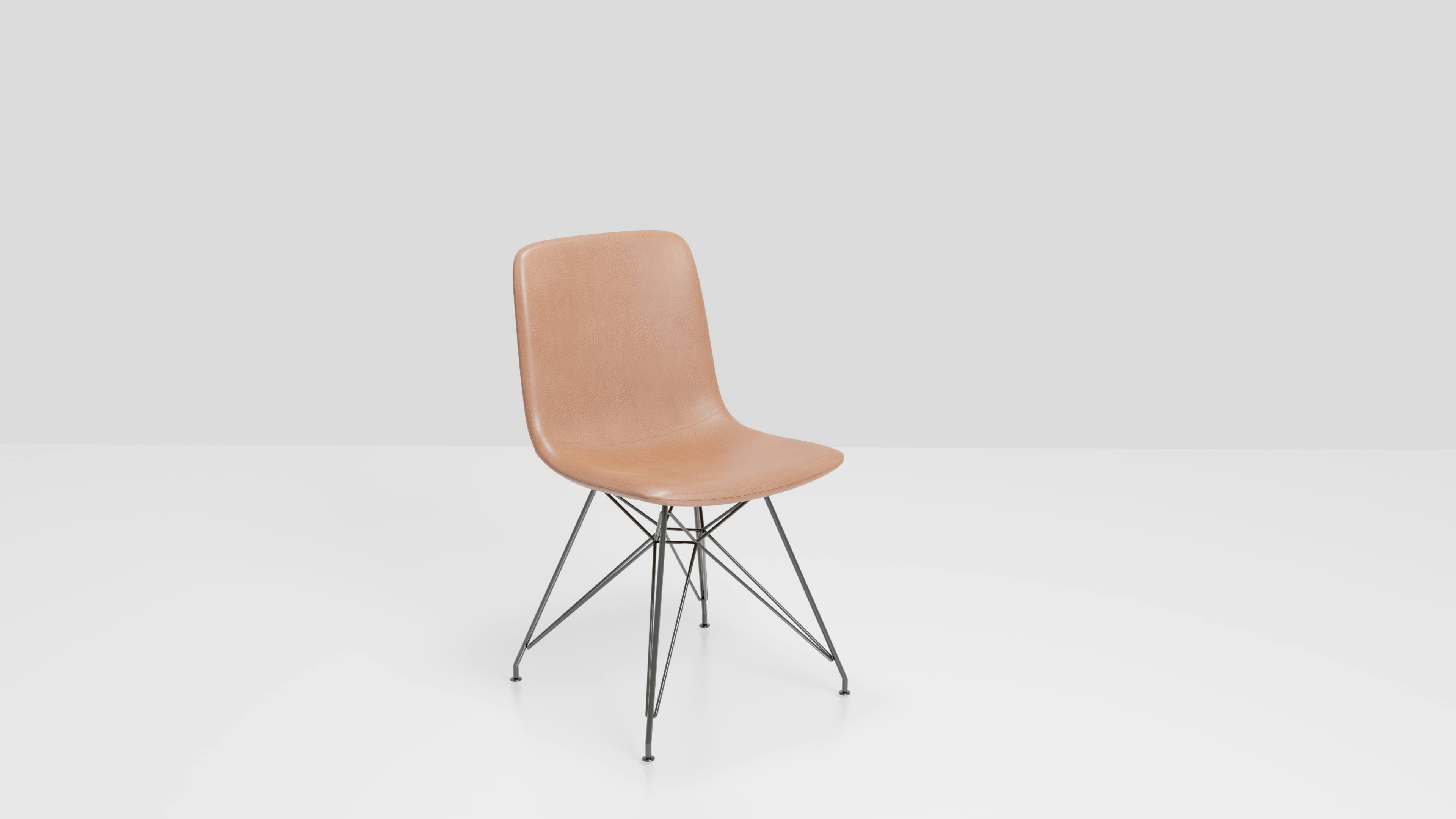 a beige chair with a black metal frame