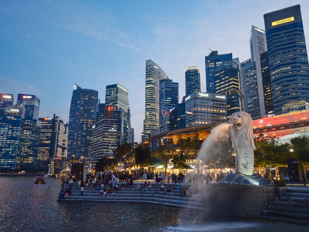 a city skyline with a fountain in the foreground