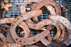 a pile of rusted metal rings sitting on top of a metal grate
