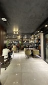 Modern restaurant interior with warm lighting and stylish urban decor filled with happy diners.