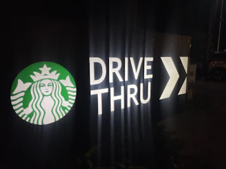 The drive-through window of evlo coffee company with a car receiving a coffee order.