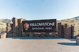 a sign for yellowstone national park on a sunny day