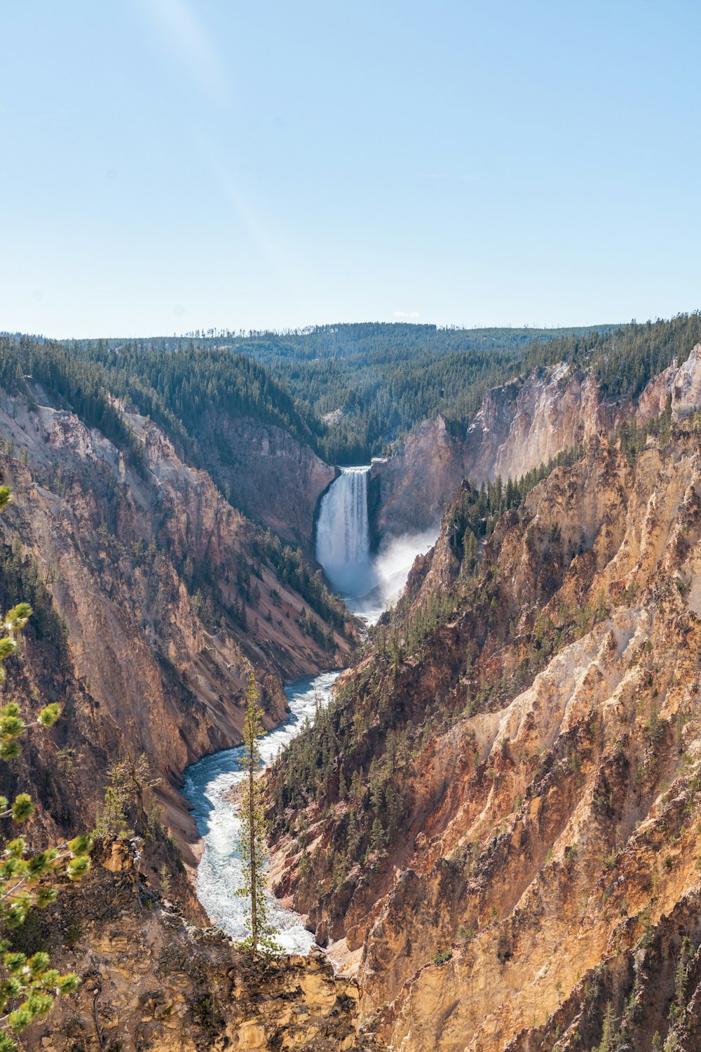 a view of a canyon with a waterfall in the distance