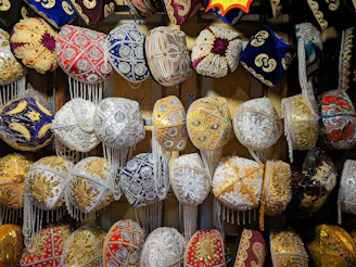 A colorful collection of personalized embroidered hats displayed on a rustic wooden table.