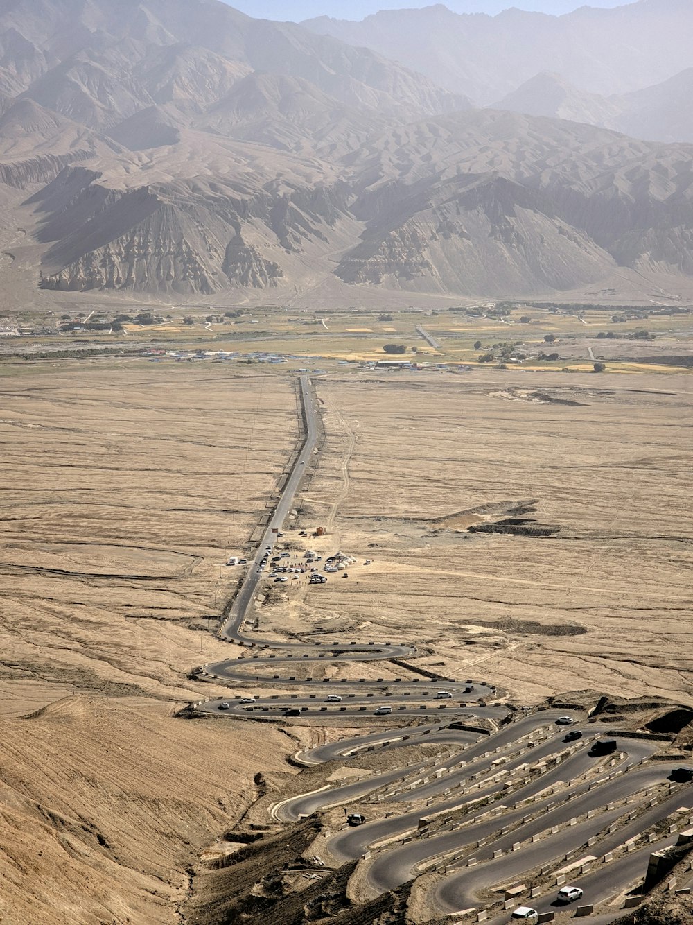 a road in the middle of a desert with mountains in the background