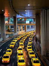 Taxi vehicle waiting calmly at São Paulo airport arrival zone under bright lights.