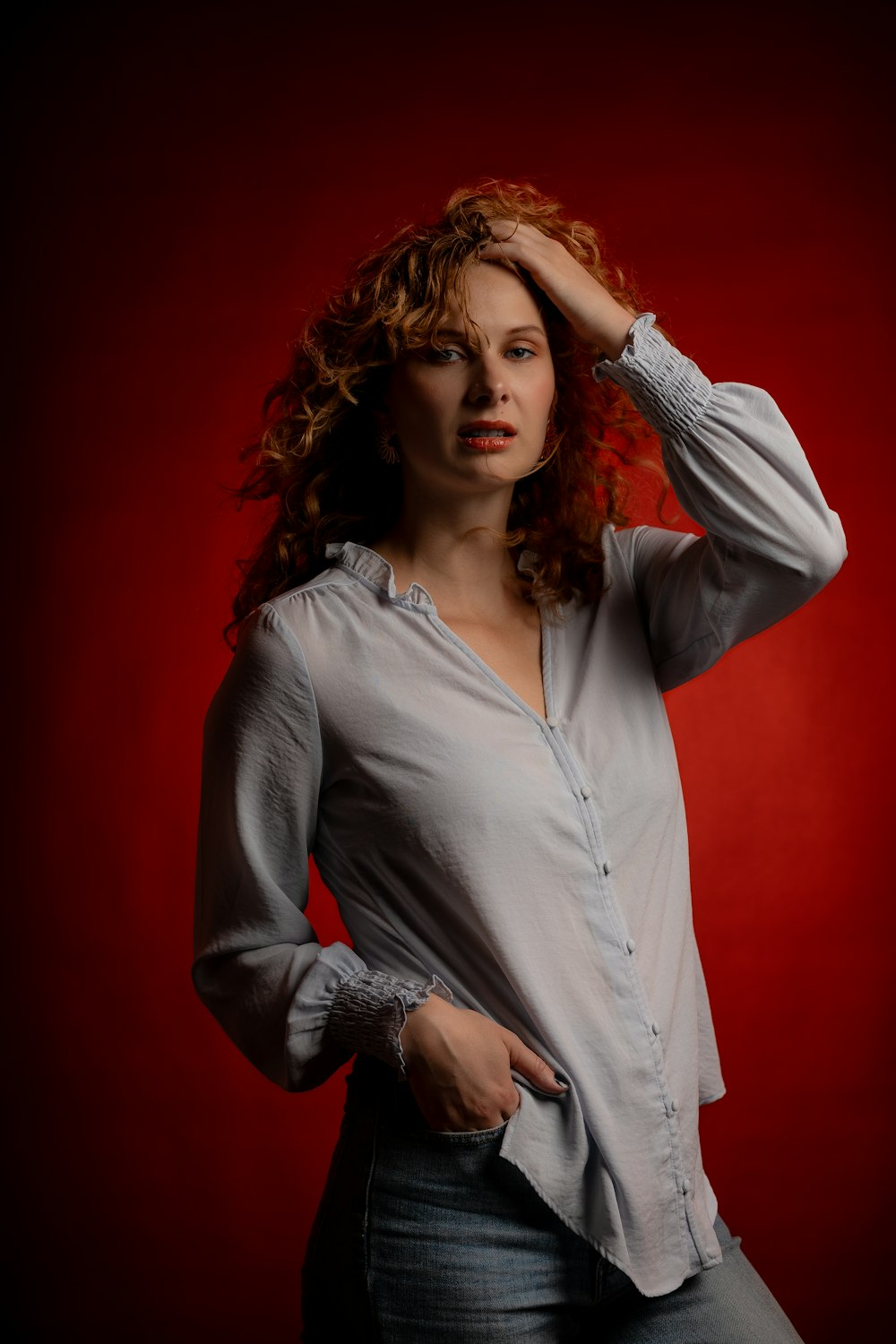 a woman with red hair is posing for a picture