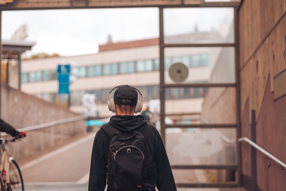 a person with a backpack walking down a street