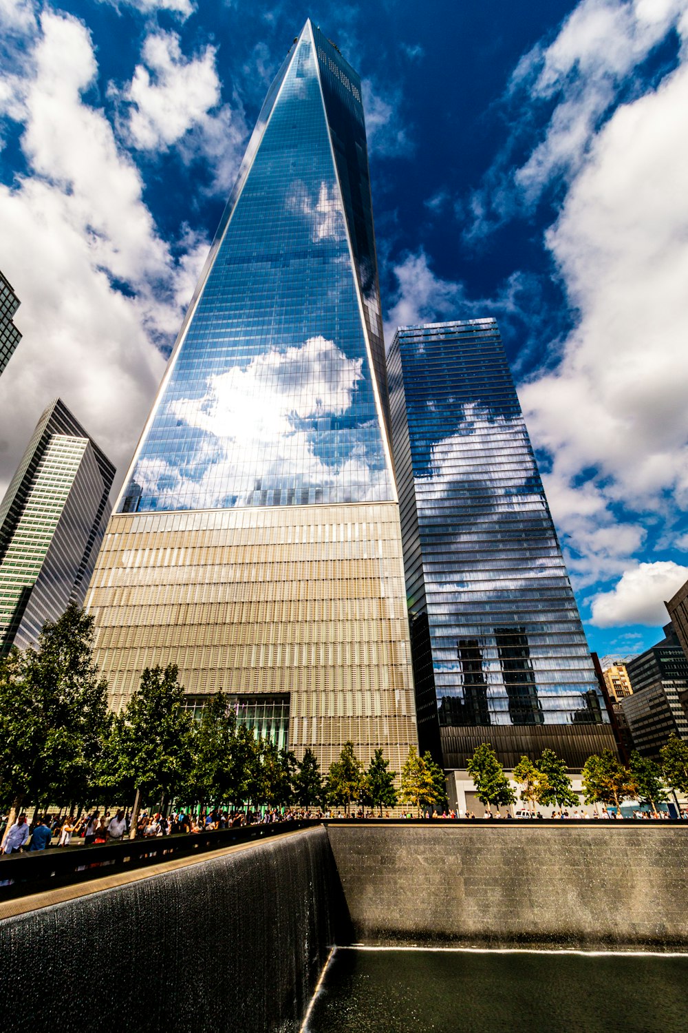 a very tall building sitting next to a body of water