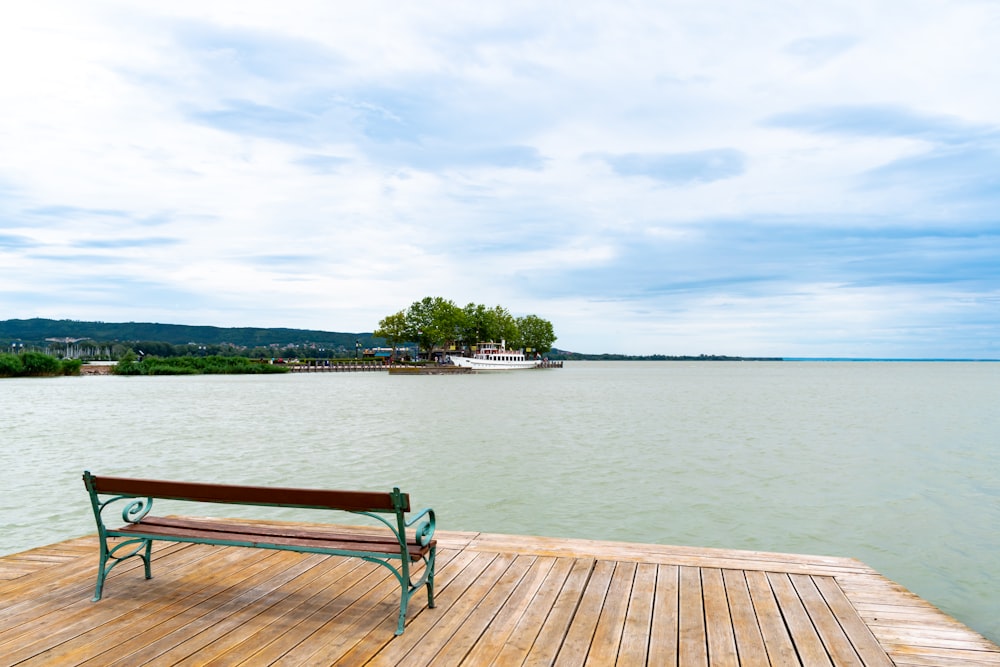 a bench sitting on top of a wooden pier