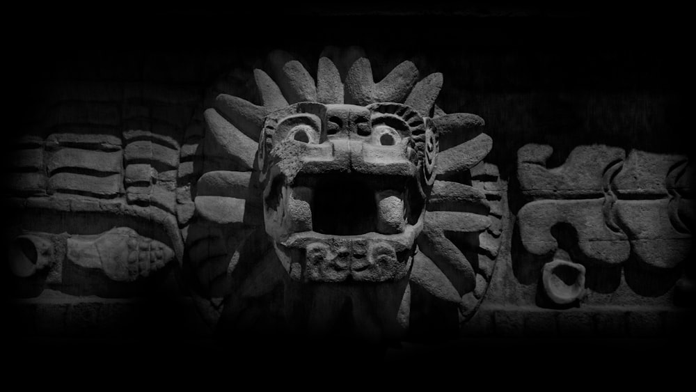 a black and white photo of a stone carving