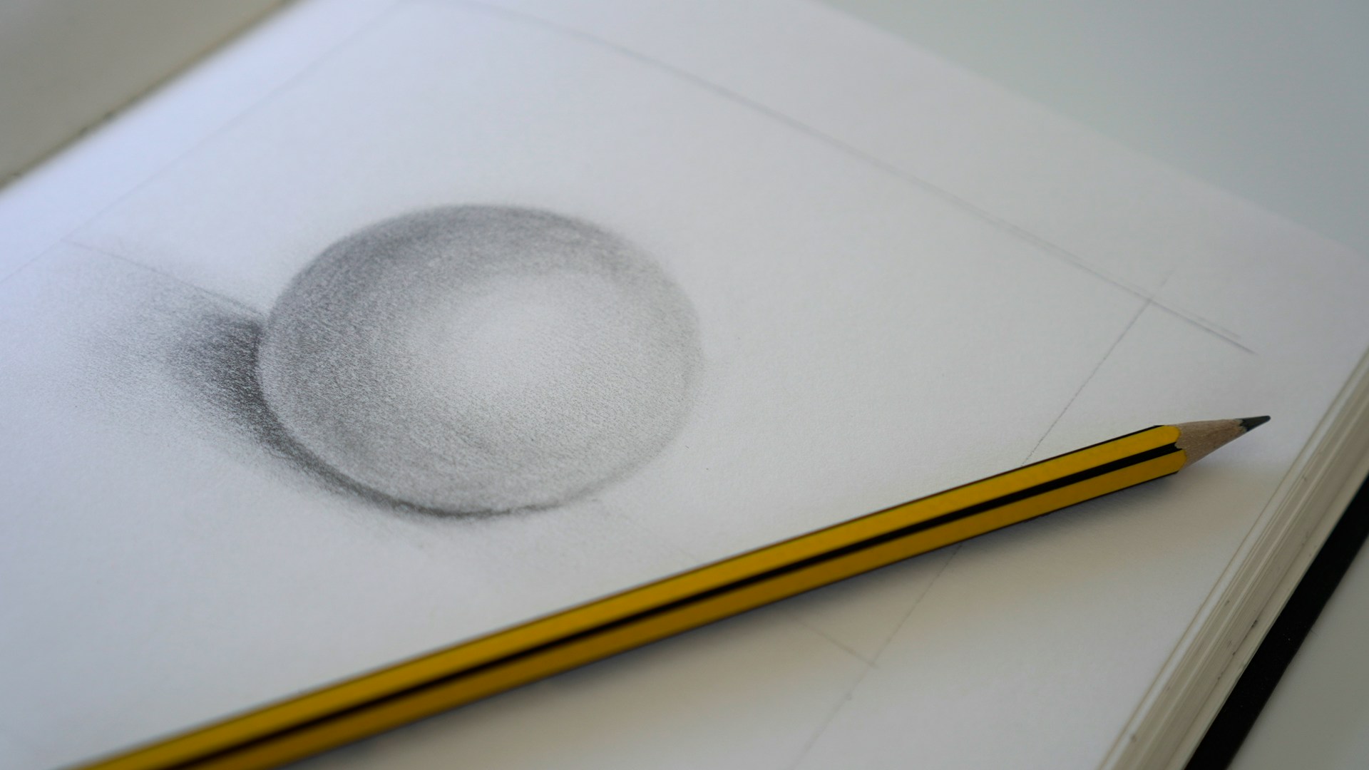 a pencil drawing of a ball and a pencil