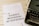 A sheet of paper with the words 'FAMILY BONDING ACTIVITIES' printed in bold, placed on a white wooden surface. There is a white pen next to the paper and a black typewriter partially visible on the right side.