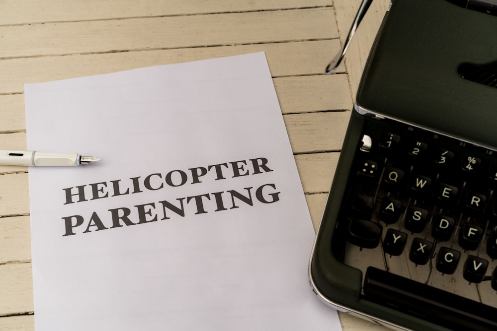 a close up of a paper with the words helicopterer parenting on it