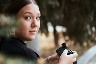 a woman holding a camera in her hands