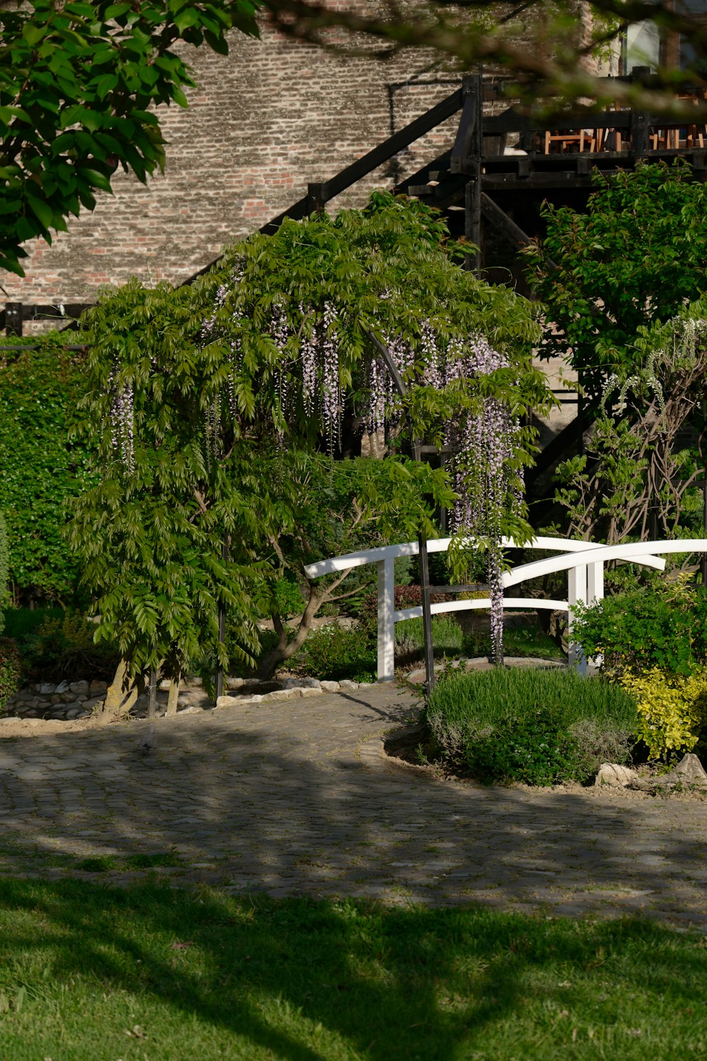 a white bench sitting in the middle of a lush green park