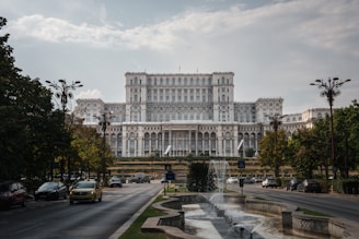 a large building with a fountain in front of it