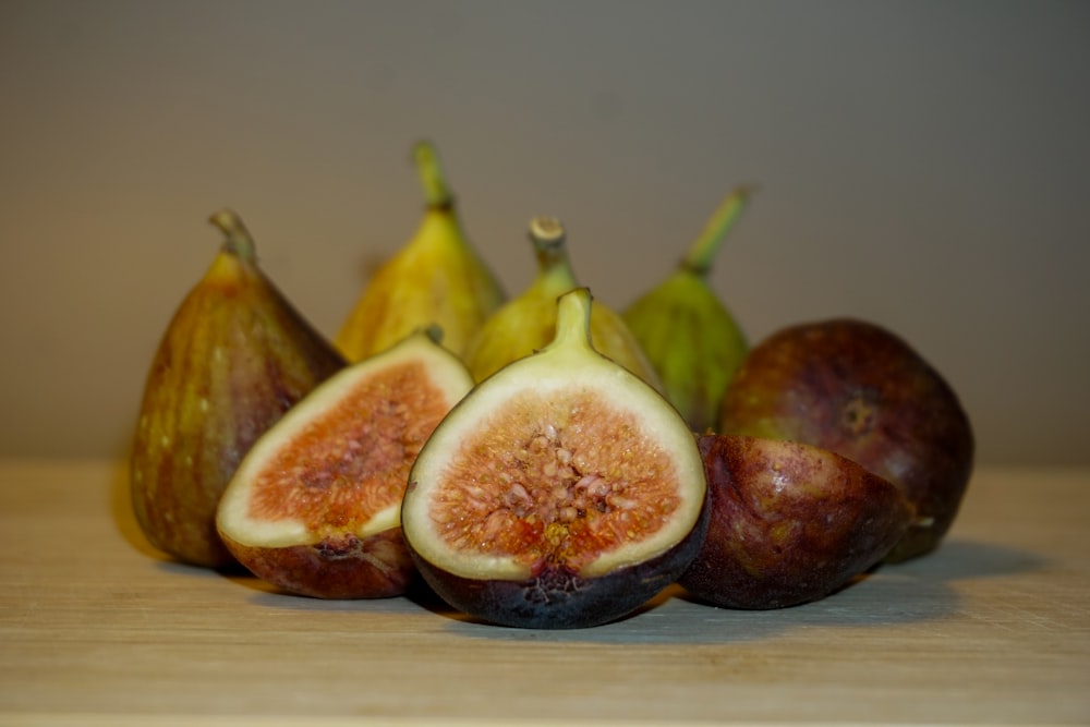 a group of figs sitting on top of a wooden table