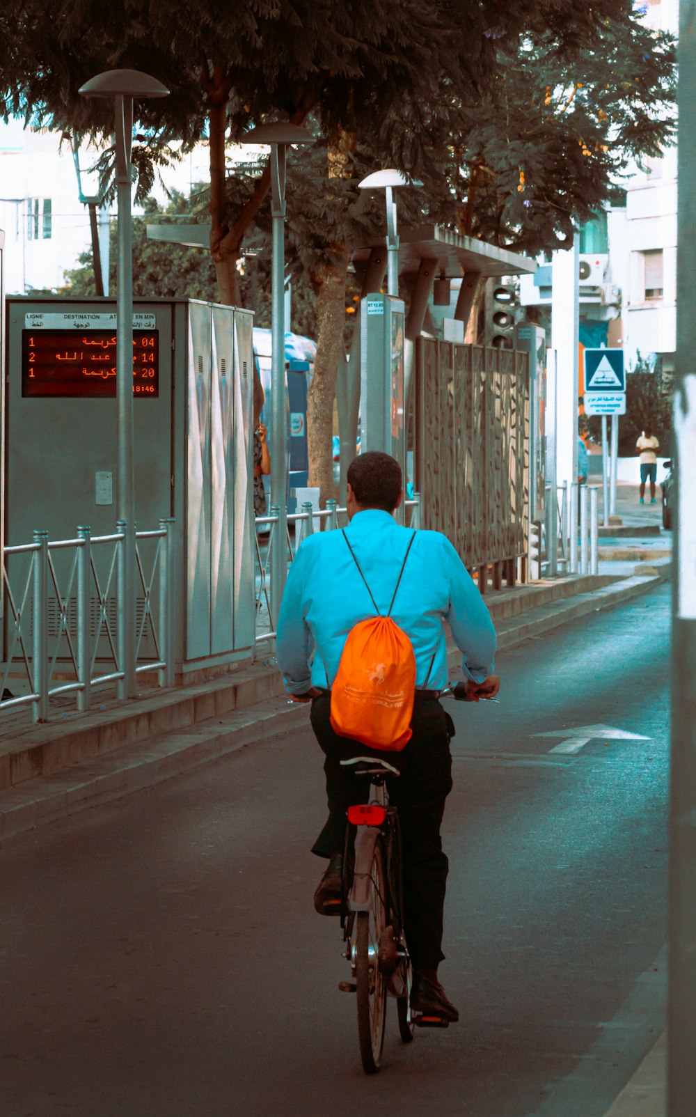 a man riding a bike down a street