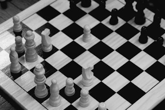 a black and white chess board with white pieces