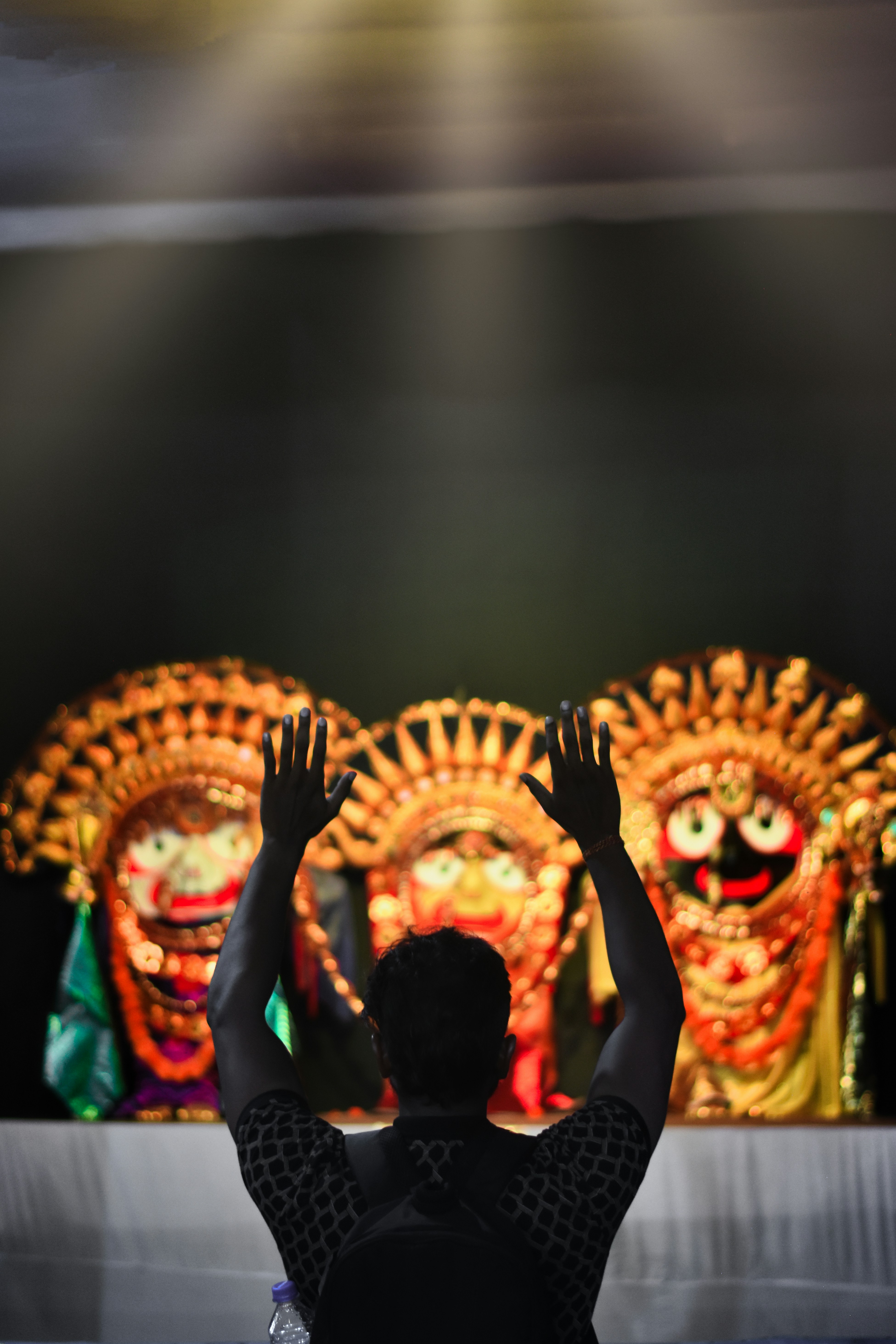 a man standing in front of a stage with his hands in the air