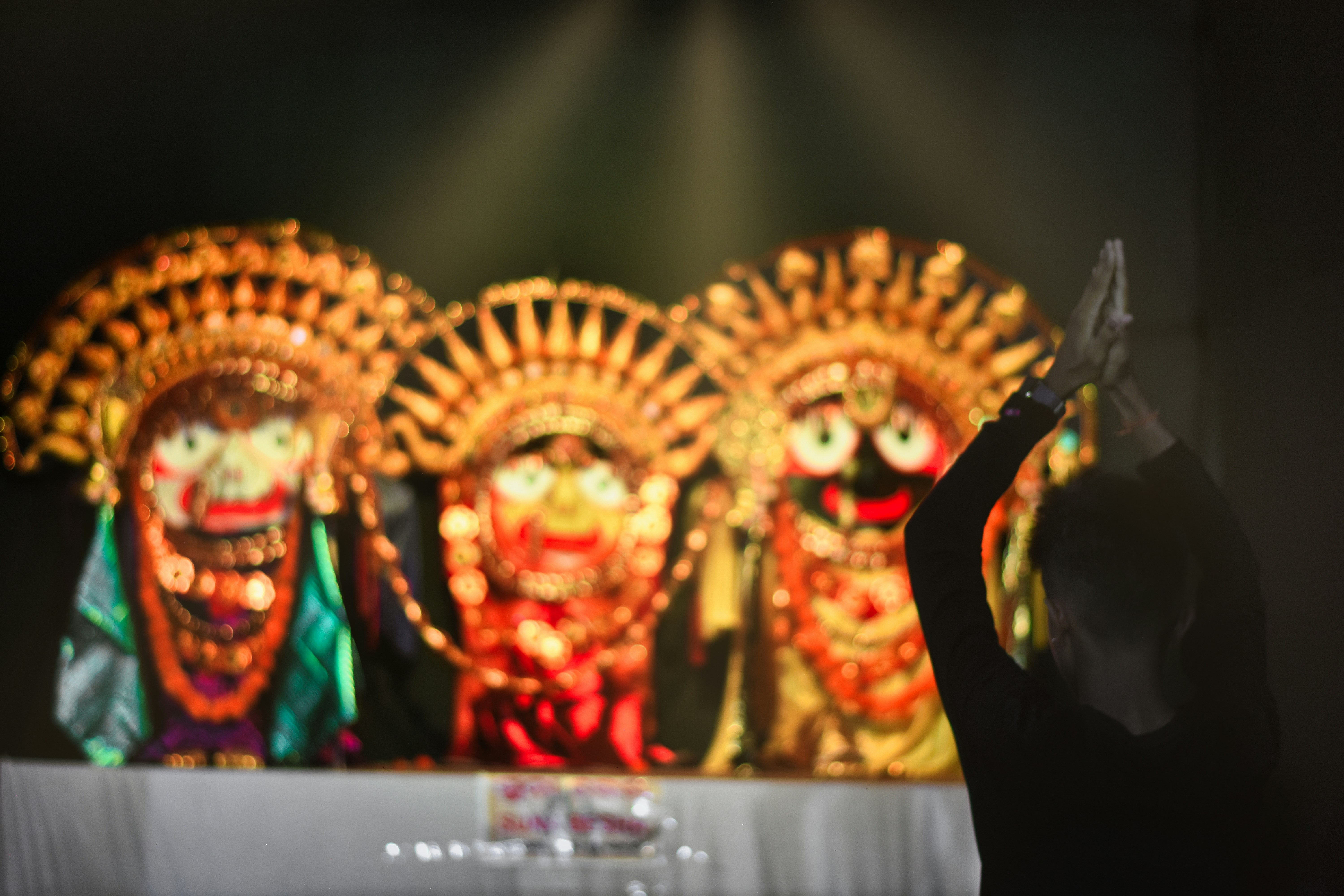 a person standing in front of a stage with masks on it