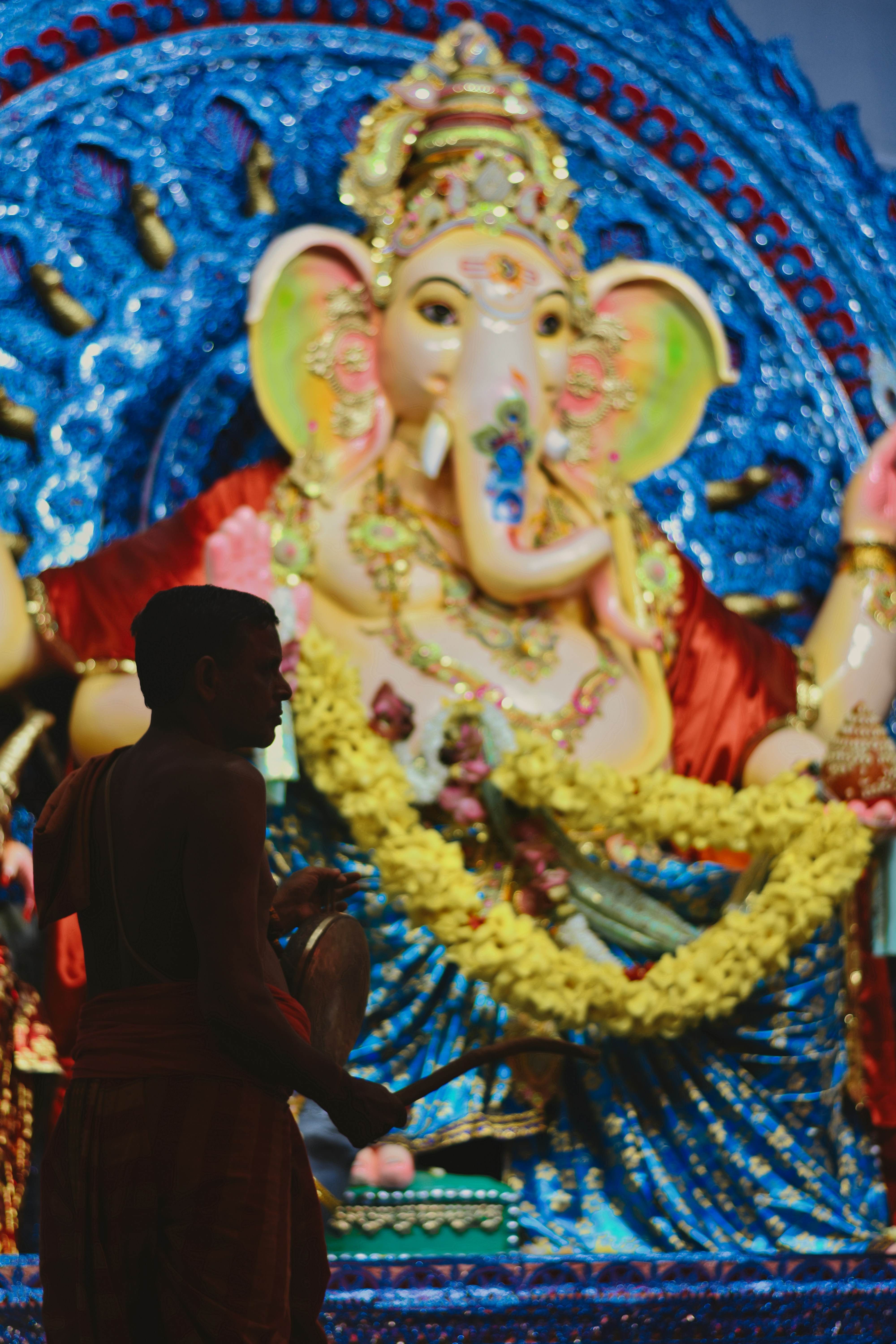 a man standing in front of a statue of an elephant