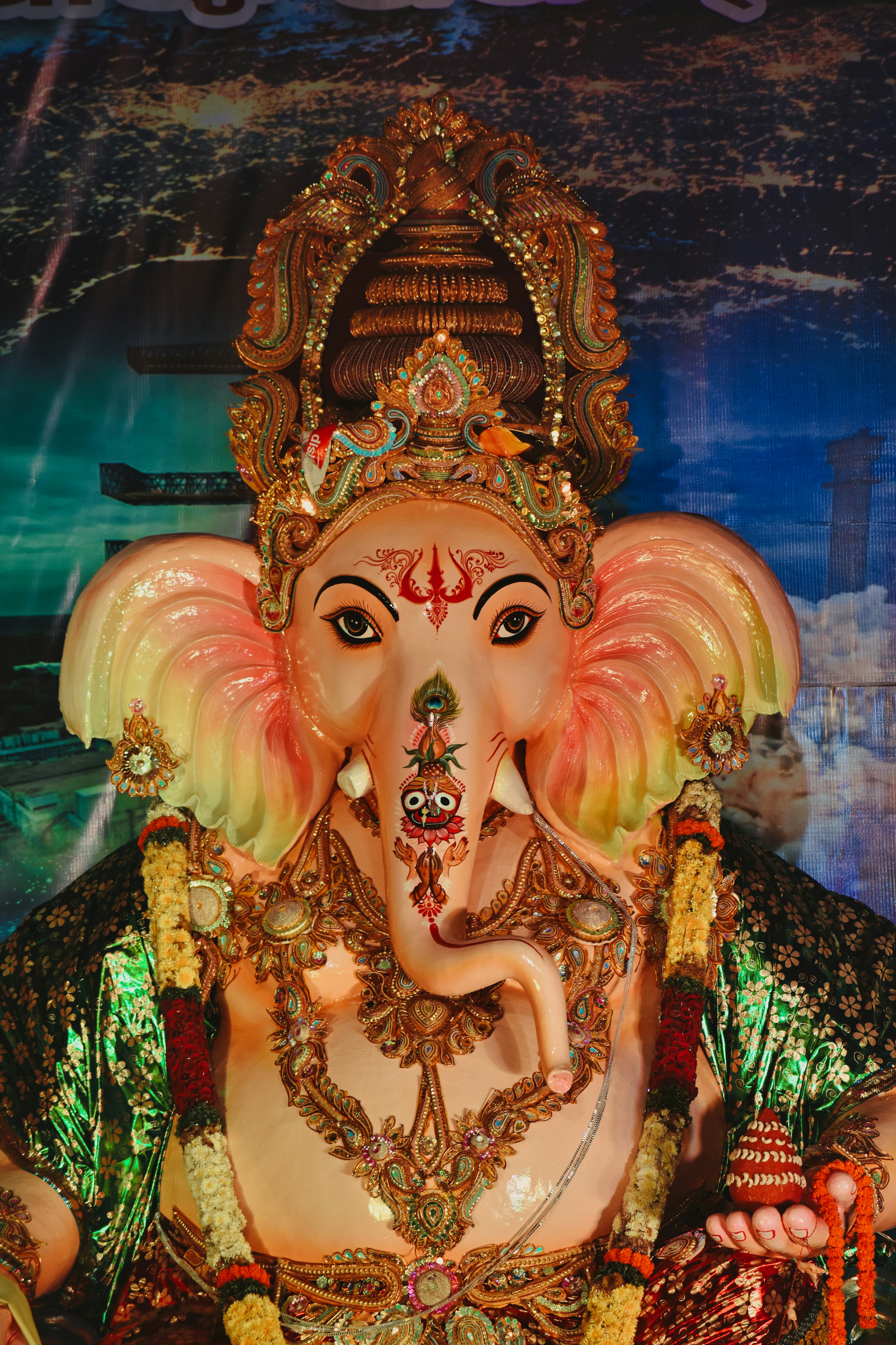 a statue of an elephant is shown in front of a painting