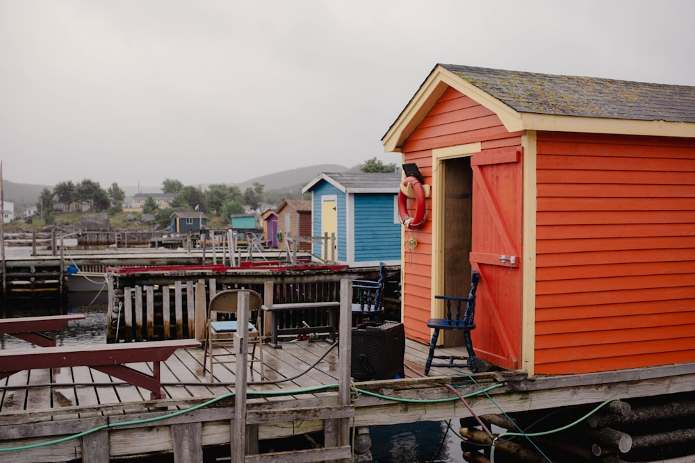 a boat dock with a red and yellow building