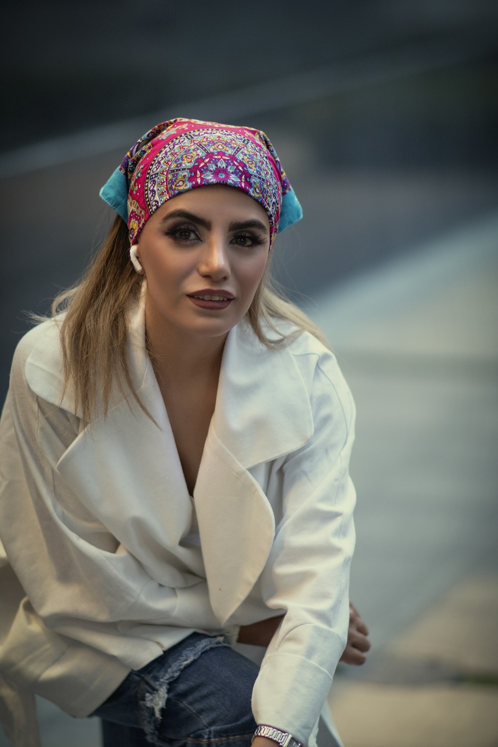 a woman sitting on a bench wearing a headband