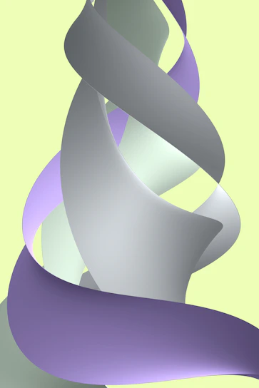 Soft pastel-colored ribbons tied in delicate bows on a light fabric background.