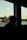 a man looking out of a window at a body of water