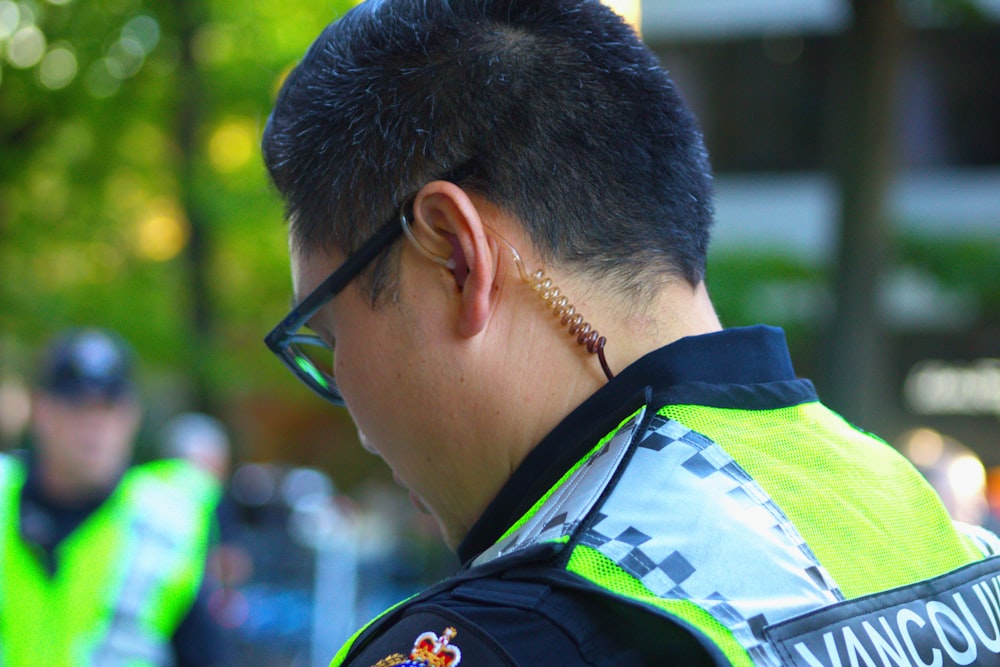 a man in a police uniform talking on a cell phone