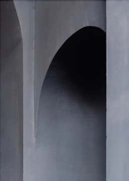 A minimalist architectural model with sharp angles and shadow play on a black background.