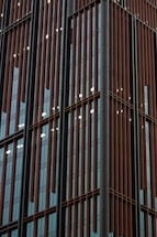 Architectural close-up of a sleek industrial building facade in navy and slate tones.