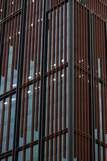 A sleek industrial-style aluminum window installation in progress at a modern building site.