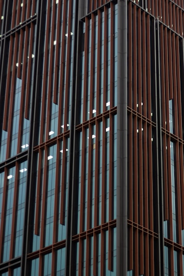 A detailed close-up of a sleek aluminum window frame freshly installed on a modern building facade.